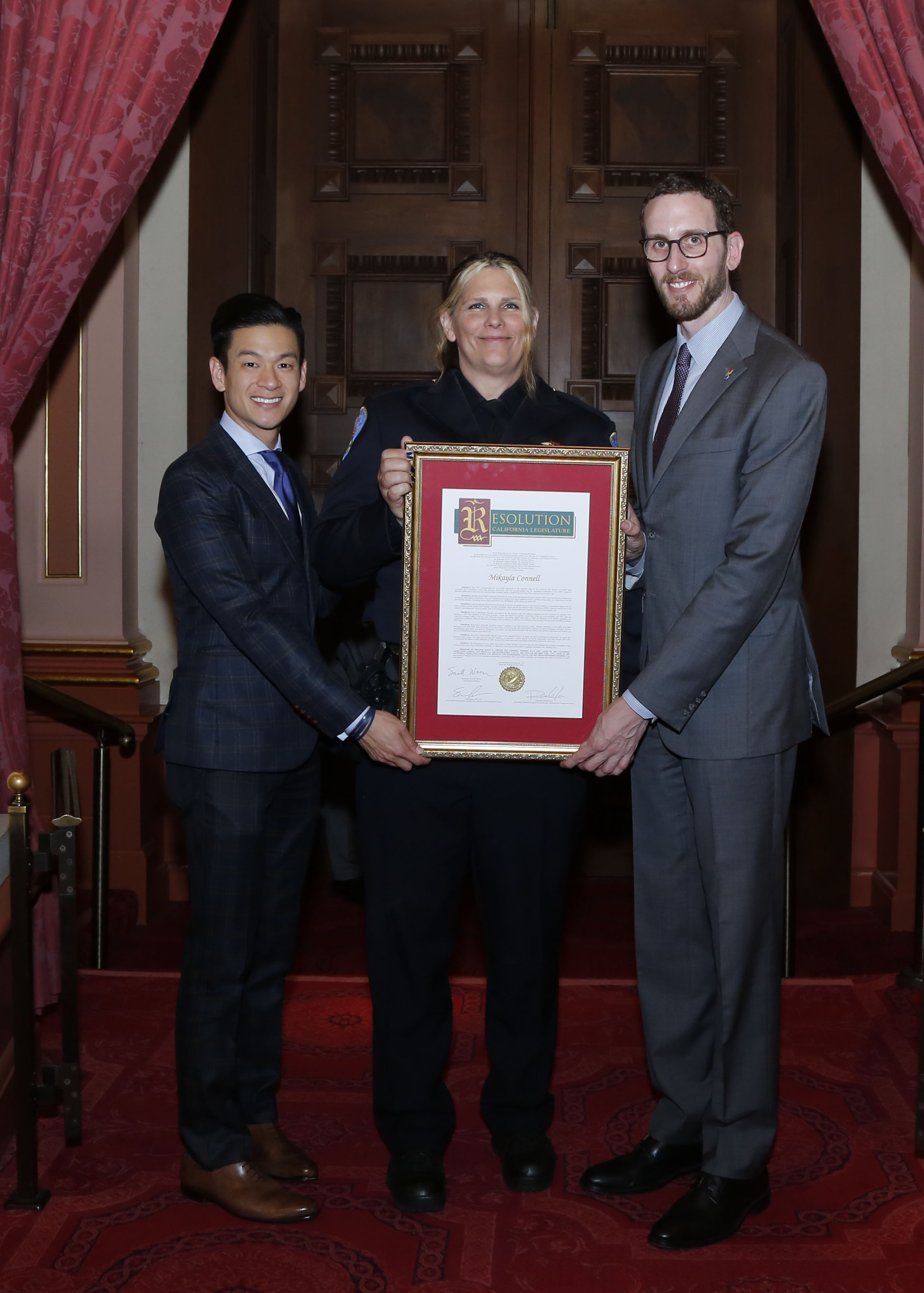 Photo of Officer Connell holding the award