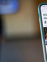 Woman holding cell phone with article Where Police Reform Has Worked, New York Times, June 11, 2020 by David Leonhardt